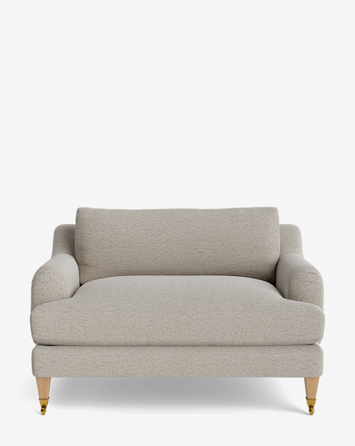 The Lucille English Roll Arm Chair and a Half features light beige upholstery, rounded arms, a plush down-wrapped cushion back, and wood legs with small brass casters on the front legs, shown against a plain white background by McGee & Co.