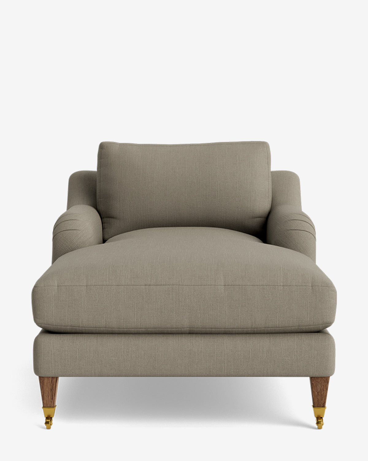 The Lucille English Roll Arm Lounge Chair, shown against a white background, features a wide, light brown design with deep seat, down-wrapped cushion, rounded arms, wooden legs (front with brass castor wheels), and is customizable by McGee & Co.