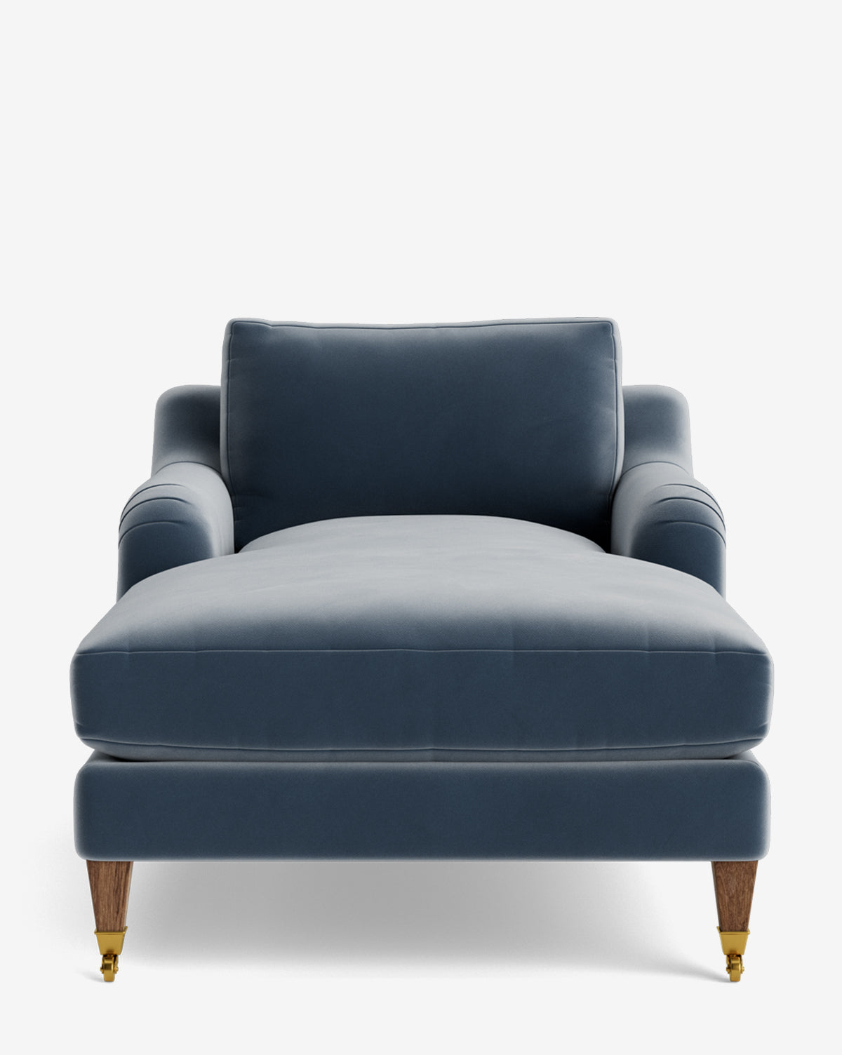 A front view of the Lucille English Roll Arm Chaise Lounge in plush blue velvet with wooden legs, brass caster wheels, and a down-wrapped cushion, set against a plain white background by McGee & Co.