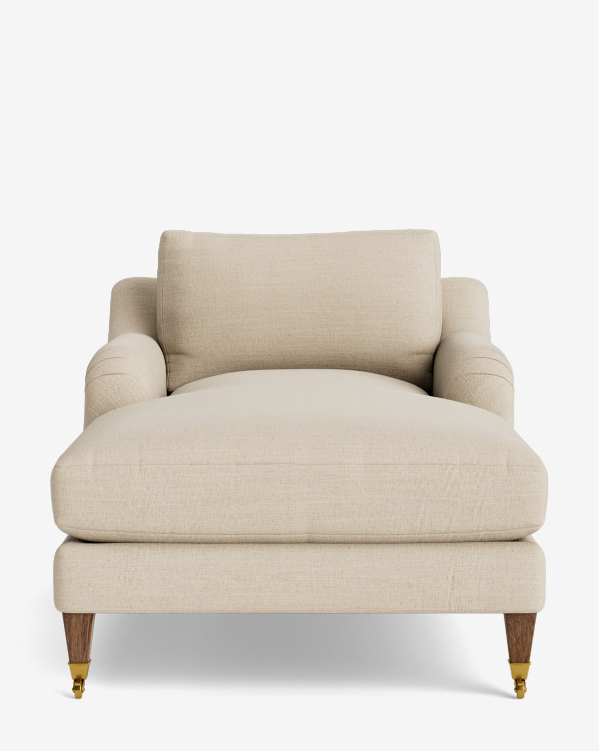 The Lucille English Roll Arm Lounge Chair is a wide, beige upholstered chaise with a backrest, low English roll armrests, wooden legs—two with brass casters—and a plush down-wrapped cushion, set against a plain white background by McGee & Co.