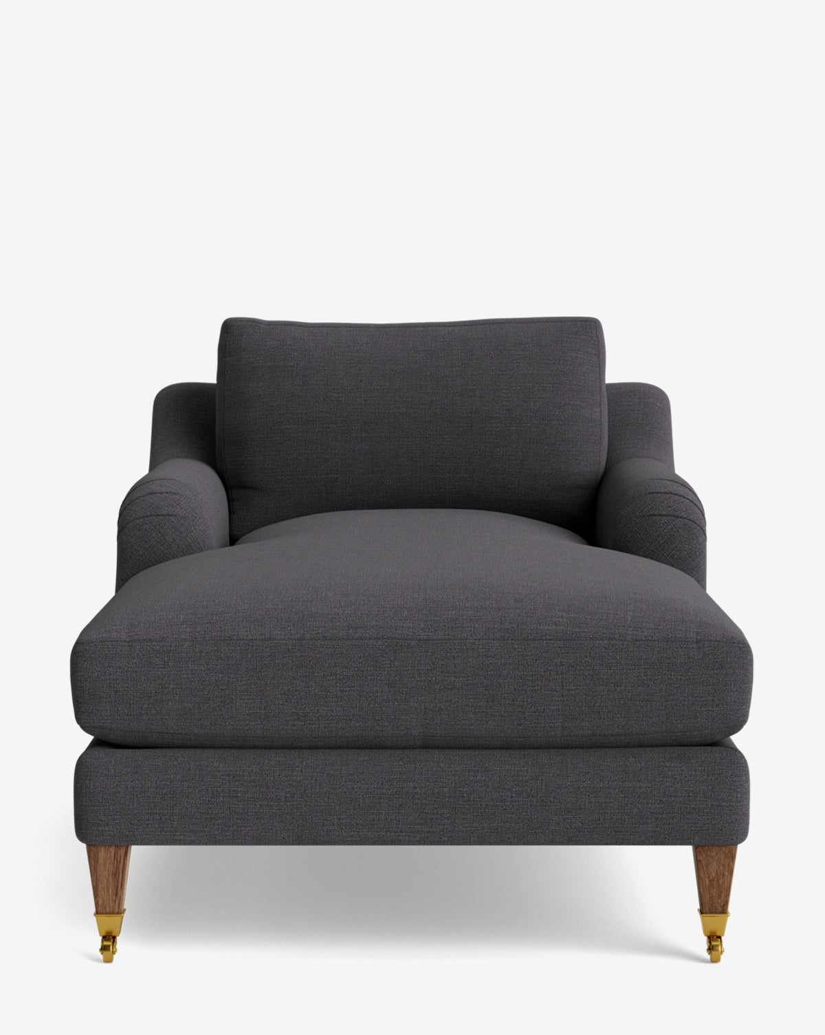 Front view of the Lucille English Roll Arm Lounge Chair, featuring modern dark gray upholstery, a wide down-wrapped cushion, low arms, and wooden legs with brass caster wheels on the front, by McGee & Co.