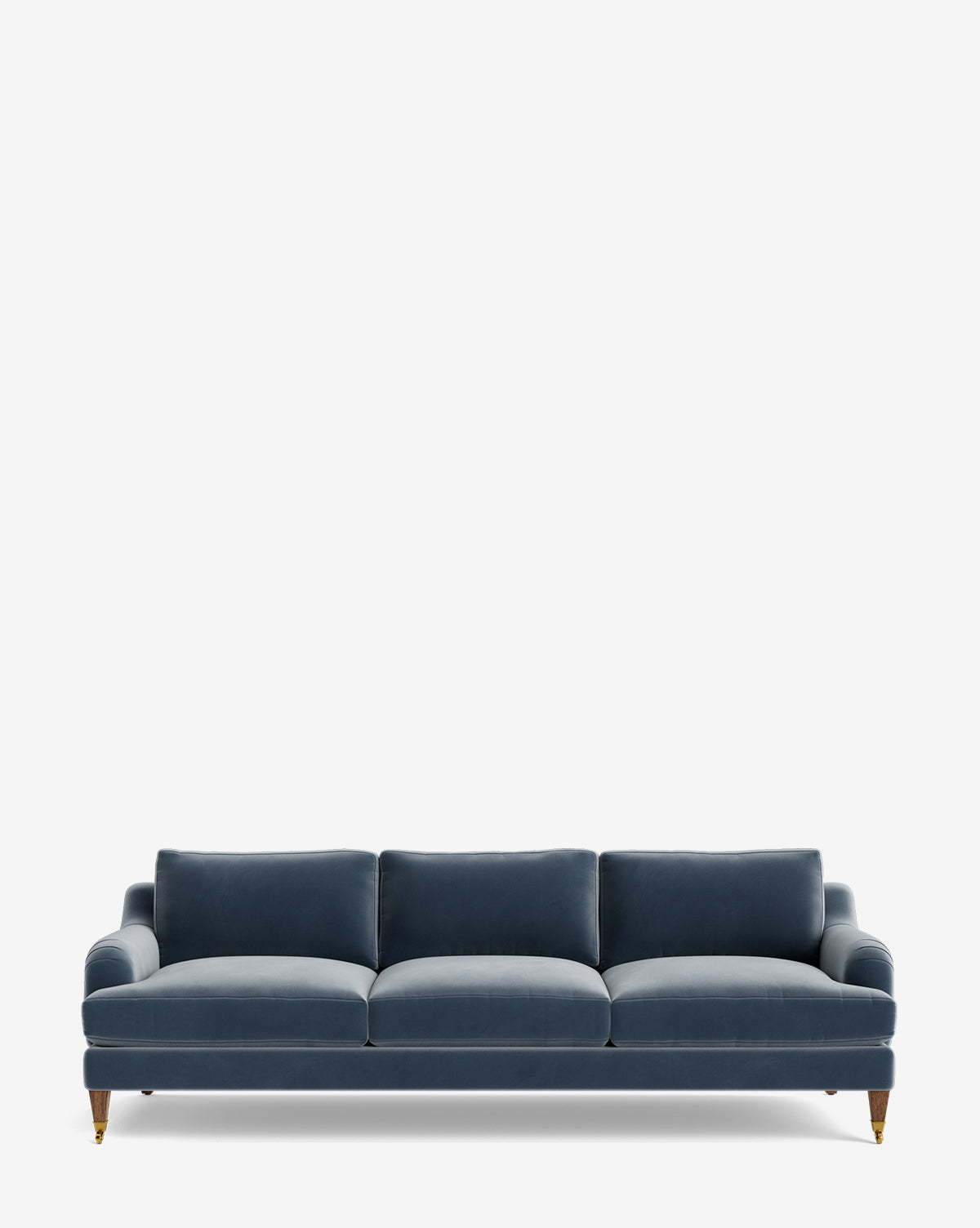 The Lucille English Roll Arm Sofa 90.5 is upholstered in blue velvet, with three down-wrapped cushions and short wooden legs featuring brass rollers, shown against a plain white background by McGee & Co.