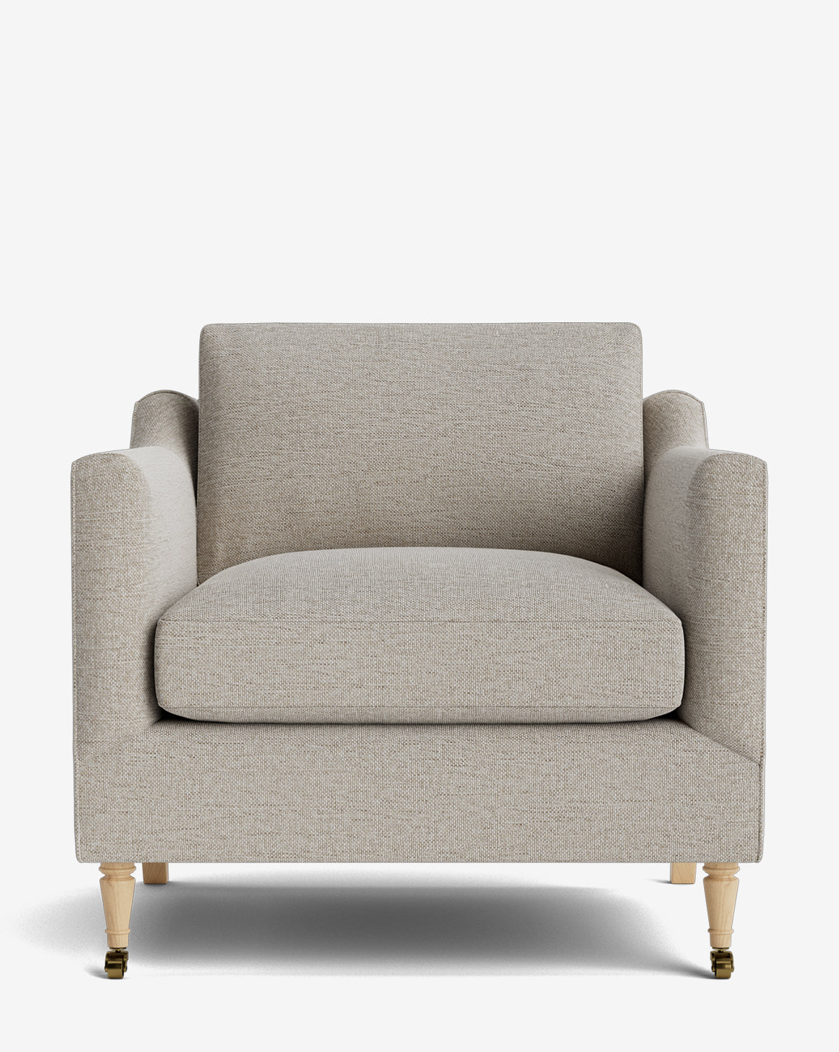 The Haverford Upholstered Lounge Chair features light beige fabric, a wide cushioned seat and back, straight armrests, and four light wooden legs with brass casters on the front two legs, by McGee & Co.