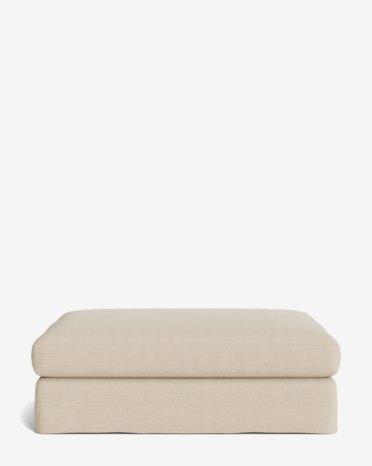 The Macy Slipcover Ottoman is a minimalist rectangular ottoman in beige with smooth edges and a cushioned top, ideal as customizable living room furniture, by McGee & Co. Shown against a plain white background.