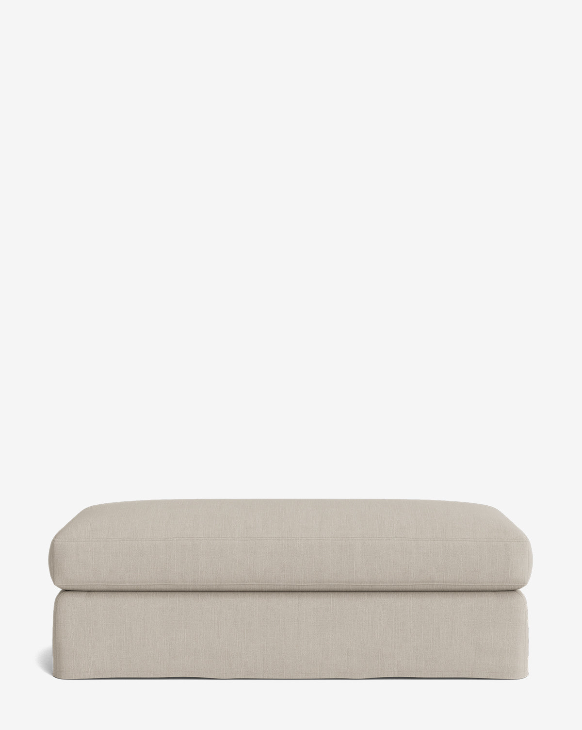 The Macy Slipcover Ottoman, in a rectangular light beige design with soft, rounded edges, sits on a plain white background—a stylish and comfortable addition to any living room, by McGee & Co.