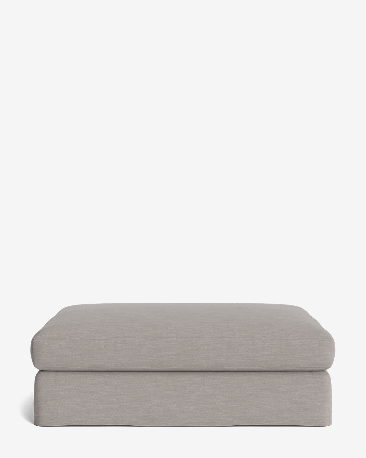 The Macy Slipcover Ottoman features a modern, rectangular design in light gray with soft, rounded edges and a minimalist look—ideal as customizable living room furniture—shown on a plain white background, by McGee & Co.