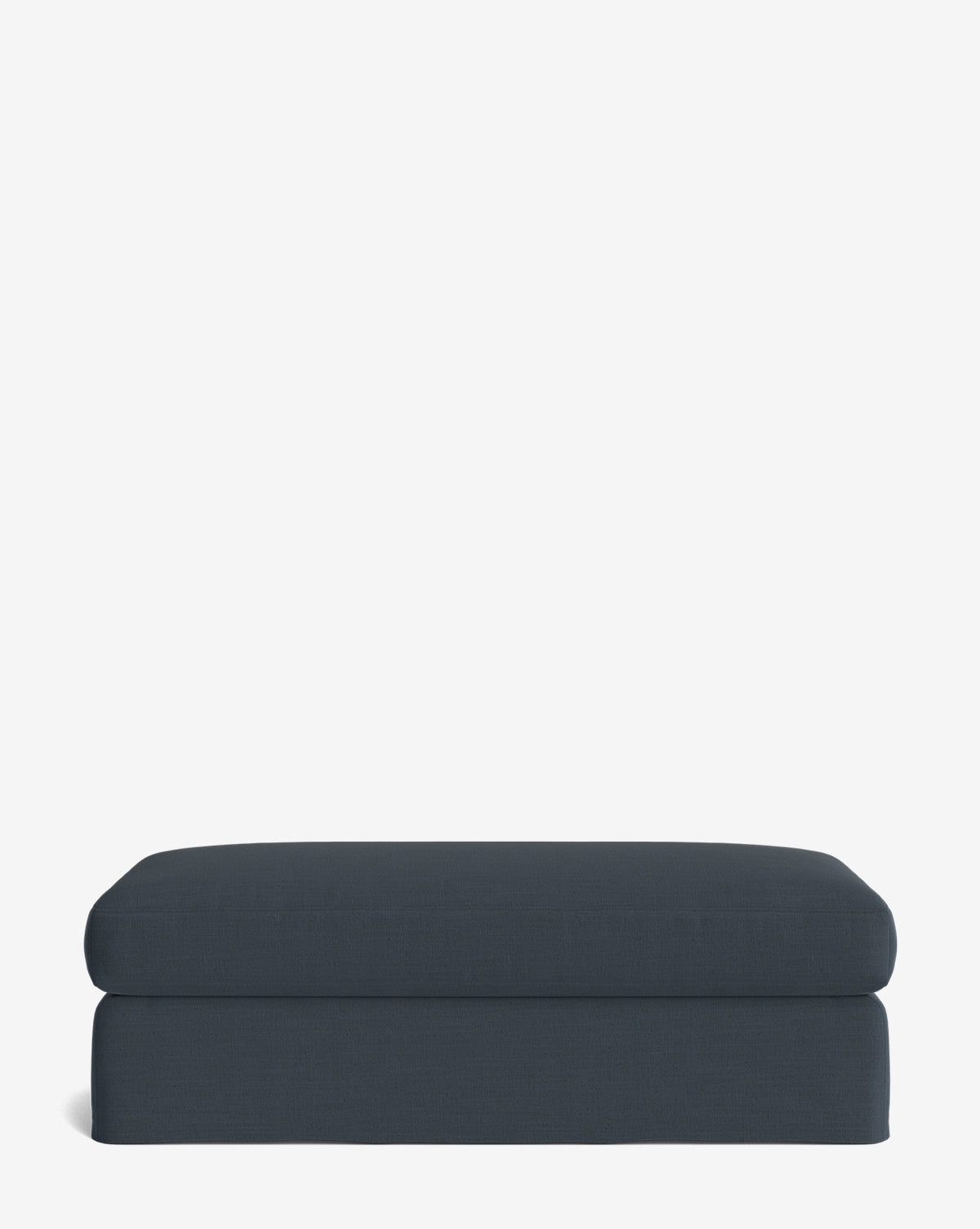 The Macy Slipcover Ottoman is a modern rectangular dark blue ottoman with a minimalist design and cushioned top—perfect for your living room, shown here on a plain white background, by McGee & Co.