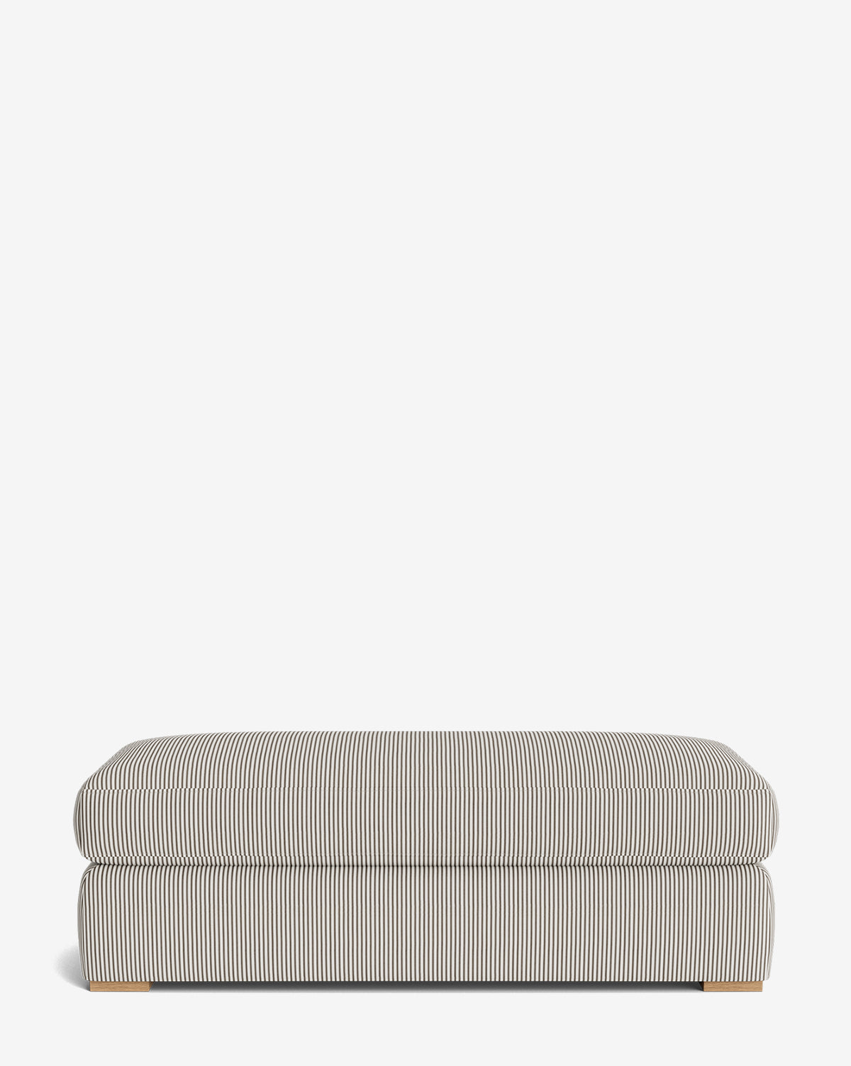 The Macy Upholstered Ottoman features thin black and white vertical stripes, a cushioned top, and low wooden legs—an ideal living room accent set against a plain white background, by McGee & Co.