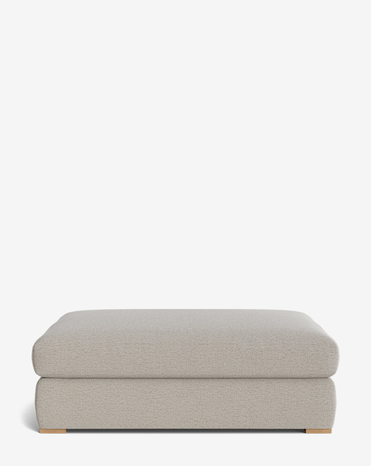 The Macy Upholstered Ottoman features a modern rectangular design in light gray with a soft cushioned top and low wooden feet—an ideal choice for your living room, shown against a plain white background by McGee & Co.
