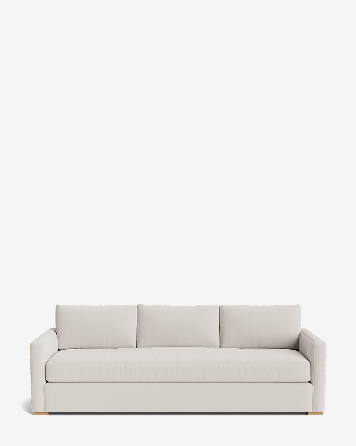 The Macy Upholstered Sofa (84-96) is a modern, light beige piece with three seat and back cushions, straight arms, and low wooden block feet, shown against a plain white background by McGee & Co.