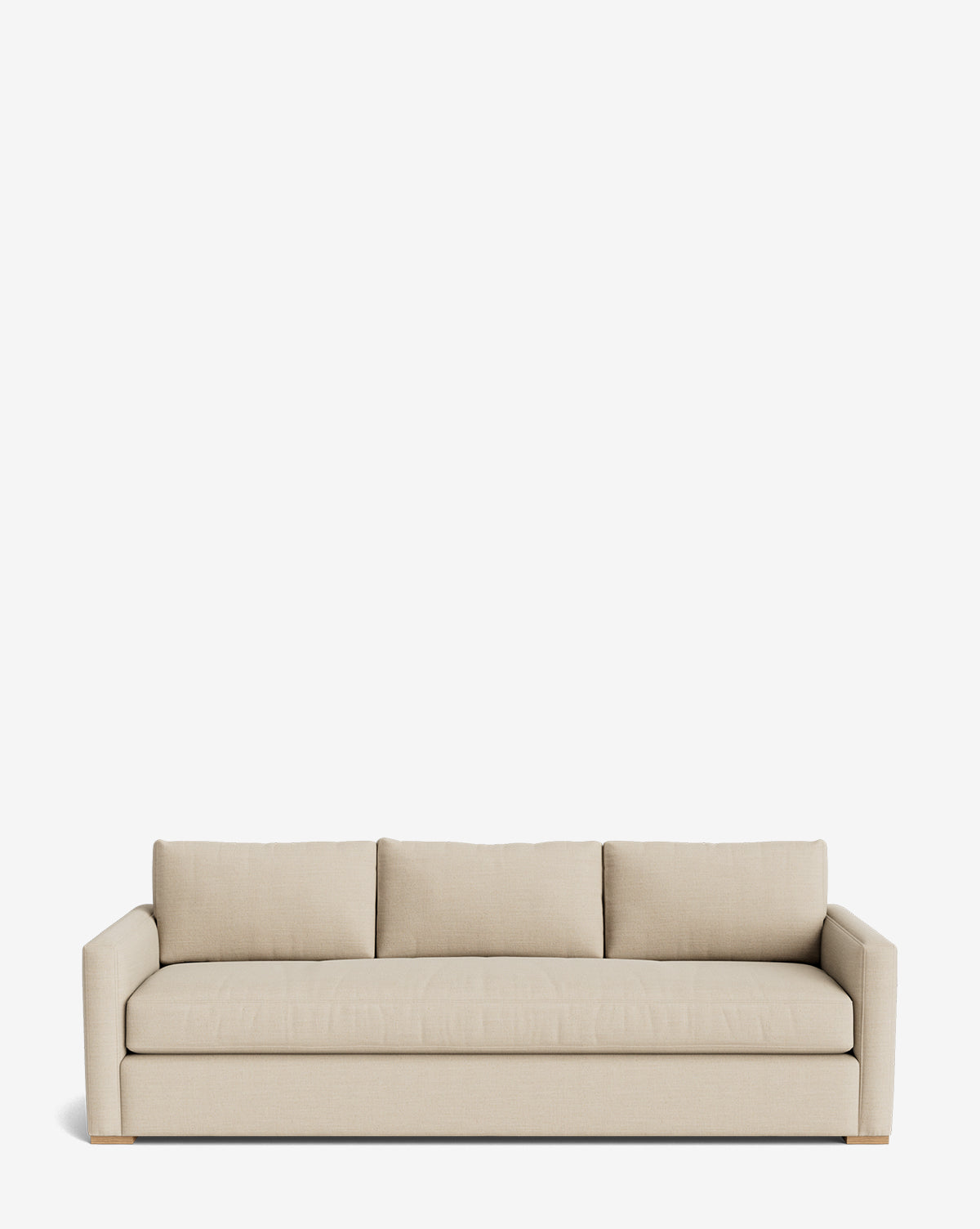 The Macy Upholstered Sofa (84-96) features modern beige upholstery, three seat and back cushions, low square arms, and wooden legs—an elegant living room piece shown against a plain white background, by McGee & Co.