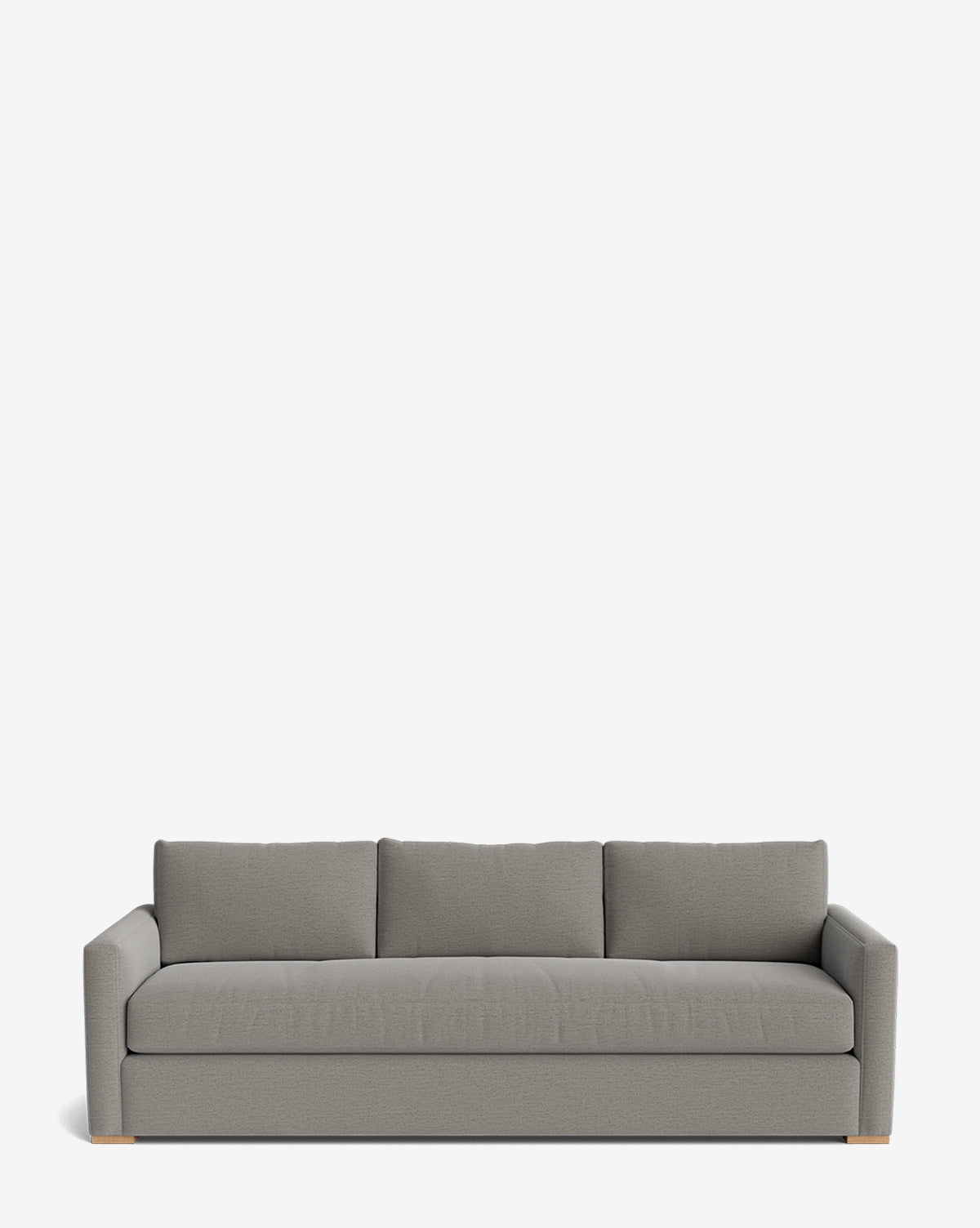 The Macy Upholstered Sofa (84-96) features a modern, light gray upholstery with three back cushions, wide armrests, and low wooden feet. Its minimalist design makes it a stylish choice for any living room, by McGee & Co. Set against a plain white background.