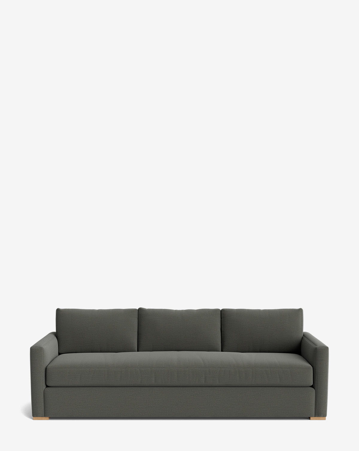 The Macy Upholstered Sofa (84-96) features a modern, minimalist design in dark gray with three back cushions, wide arms, and wooden feet—an elegant addition to any living room, shown here against a plain white background by McGee & Co.