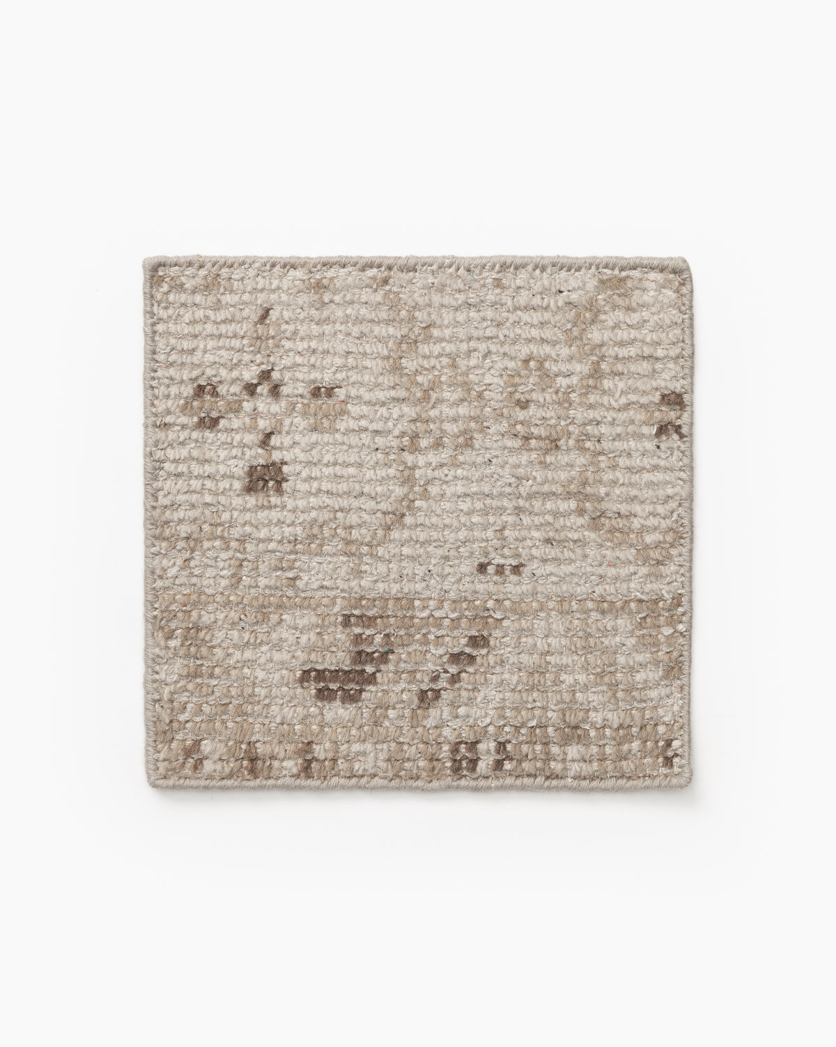 The Mali Hand-Knotted Rug Swatch is a rectangular, textured beige swatch with a subtle, faded pattern in light and dark brown tones, shown on a white background by McGee & Co.