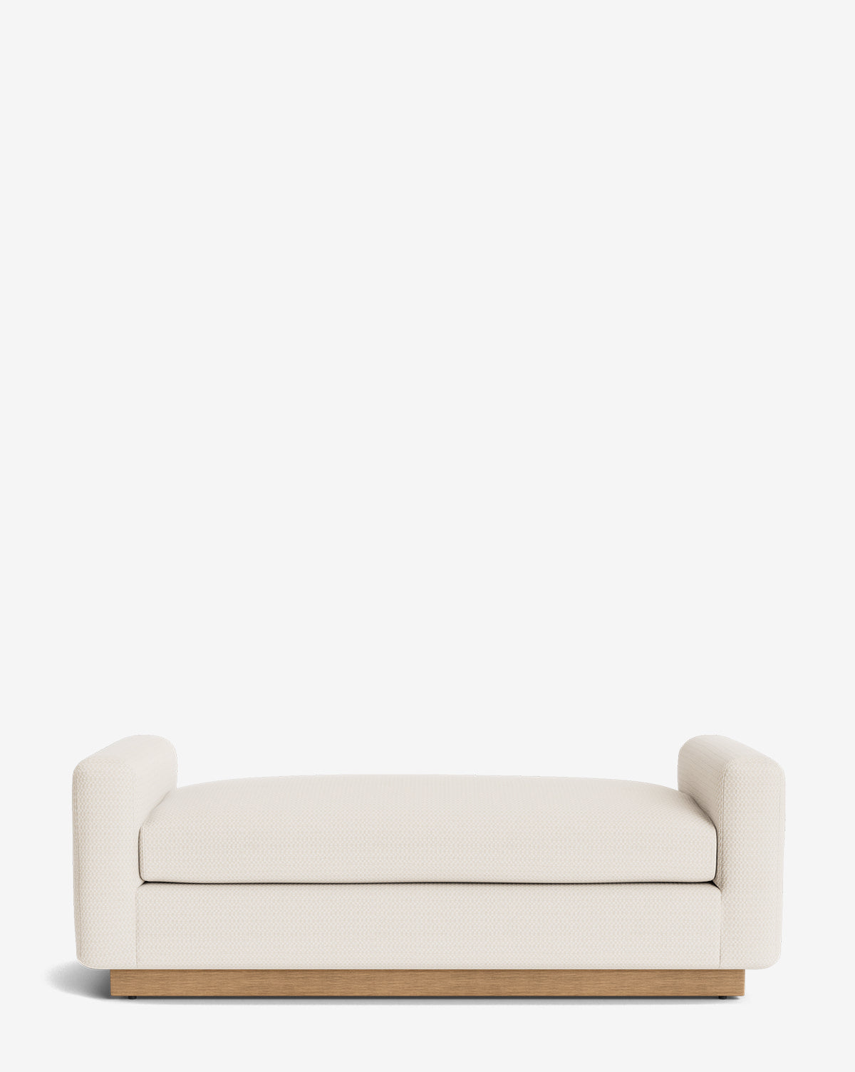 The Mansfield Bench features cream upholstery, short rounded armrests, and a wooden base. Handcrafted for contemporary sophistication, this modern, low-profile bench enhances any space by McGee & Co.