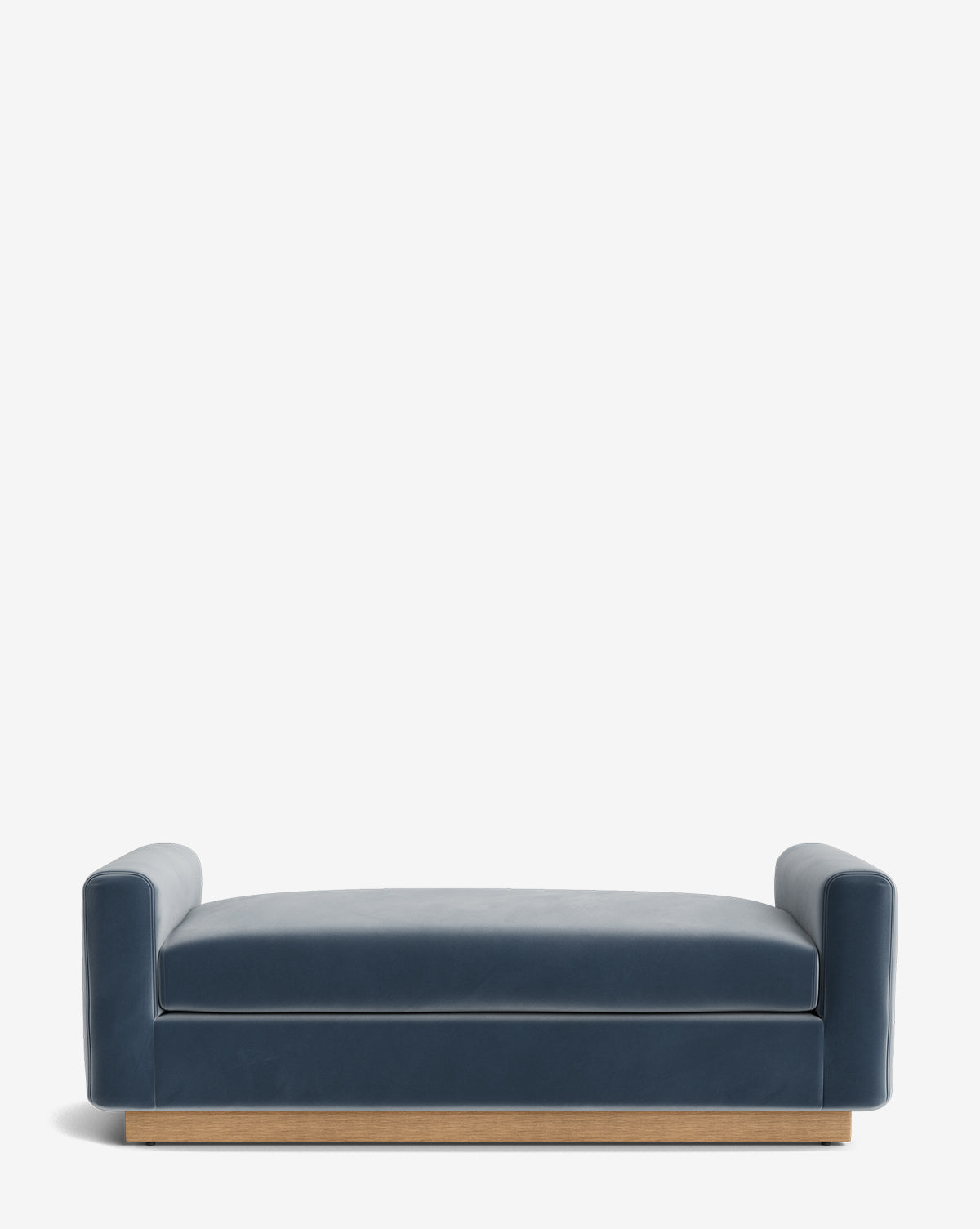 The Mansfield Bench is a modern, low-profile navy blue sofa with wide armrests and a wooden base, resembling an upholstered bench, displayed against a plain white background, by McGee & Co.