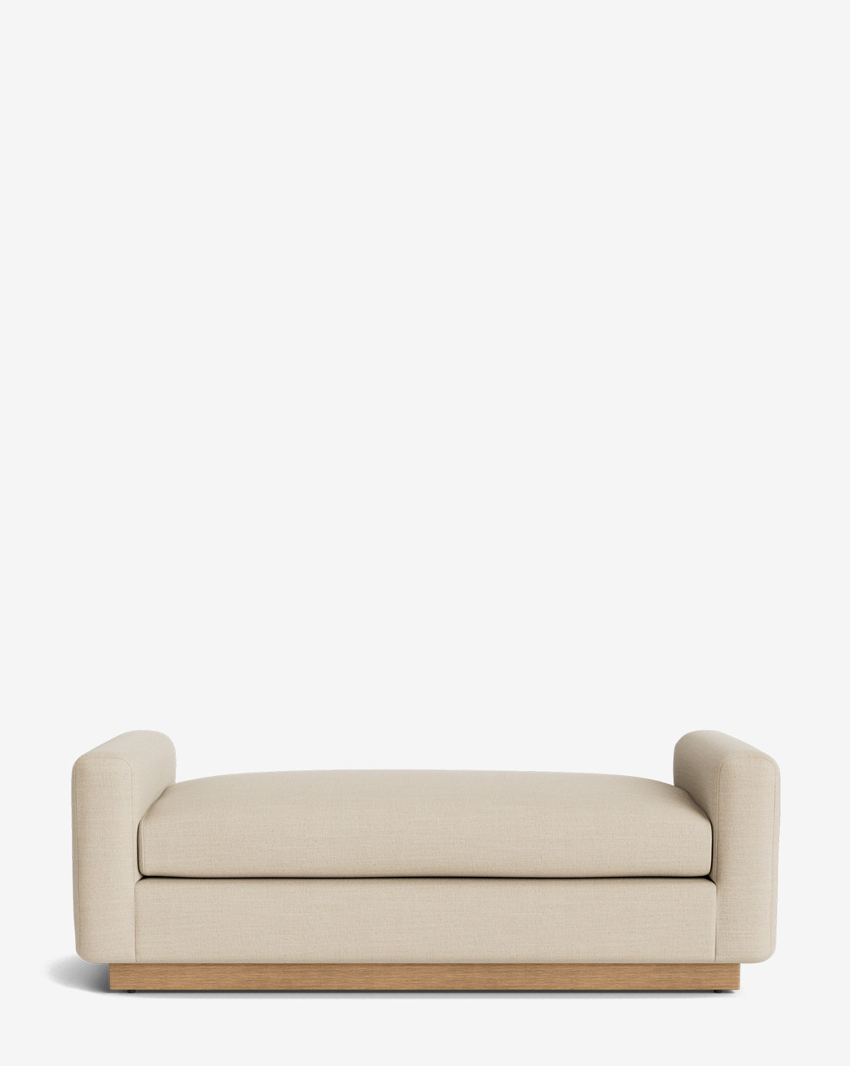 The Mansfield Bench is a modern, low-profile beige sofa with wide armrests and a wooden base. Set against a white background, its minimalist design echoes an upholstered bench, offering contemporary style and comfort by McGee & Co.