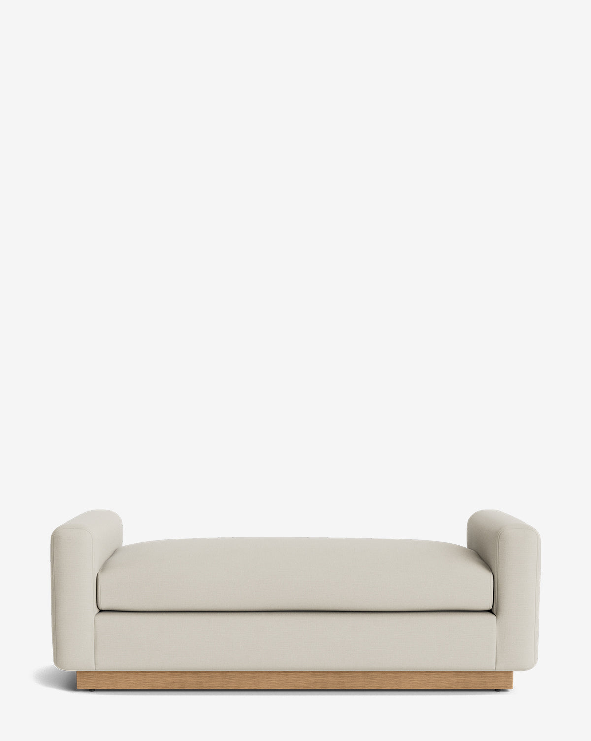 The Mansfield Bench features a modern, minimalist design with cream upholstery, low rounded arms, and a wooden base—blending comfort and style against a clean white backdrop, by McGee & Co.