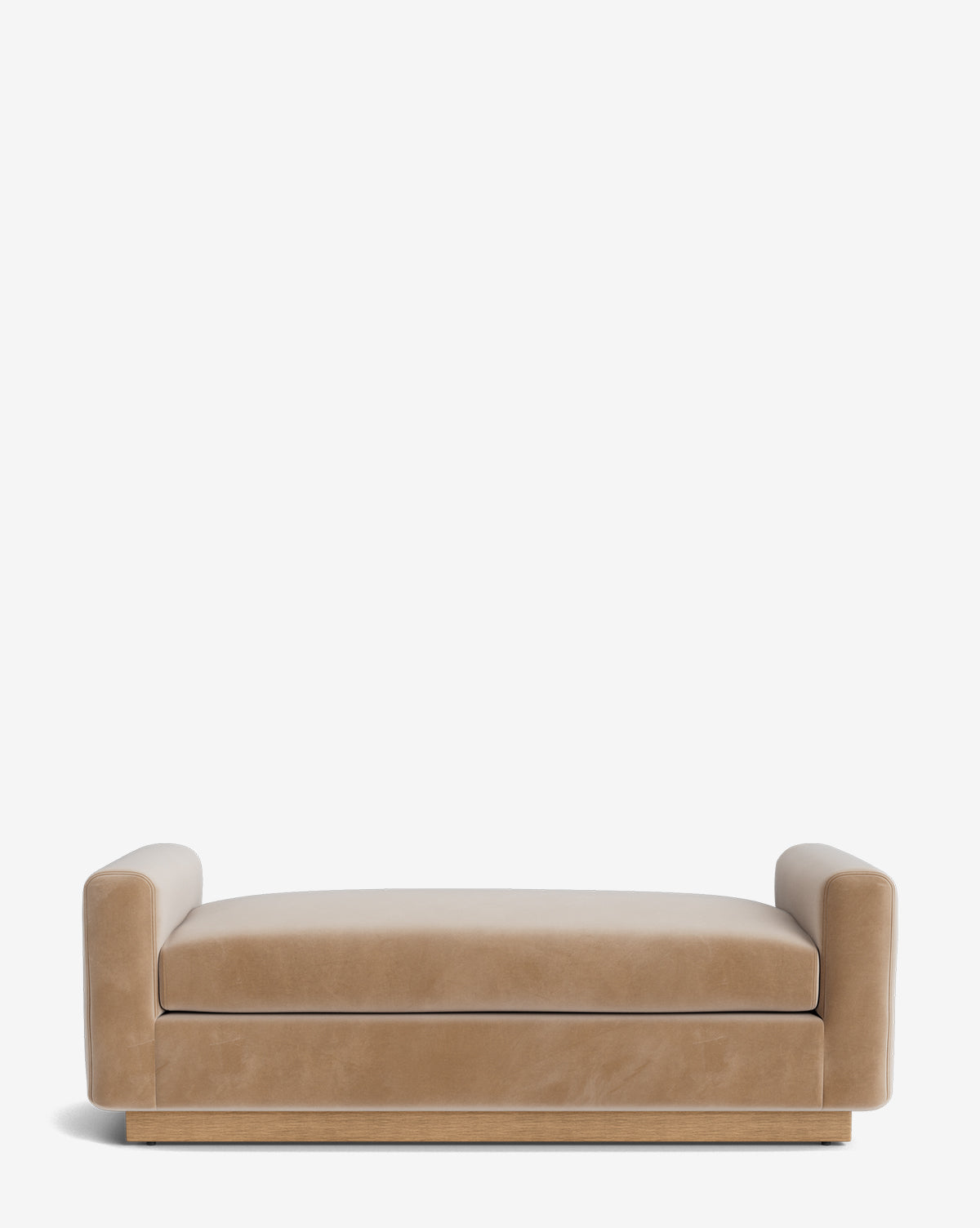 The Mansfield Bench features a modern, low-profile design in tan velvet with wide cylindrical armrests and a wooden base, evoking handcrafted elegance against a plain white background, by McGee & Co.