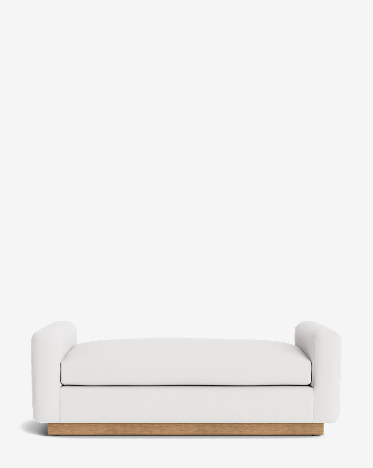 The Mansfield Bench is a modern, handcrafted piece with white upholstery, low rounded armrests, and a wooden base, shown against a plain white background, by McGee & Co.