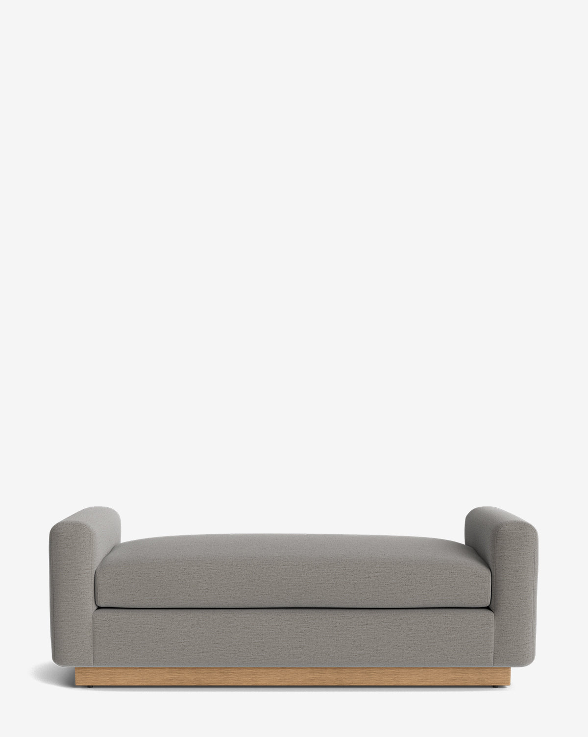 The Mansfield Bench features modern gray upholstery, low rounded arms, and a wooden base, adding timeless style and comfort to any space. Shown against a plain white background by McGee & Co.