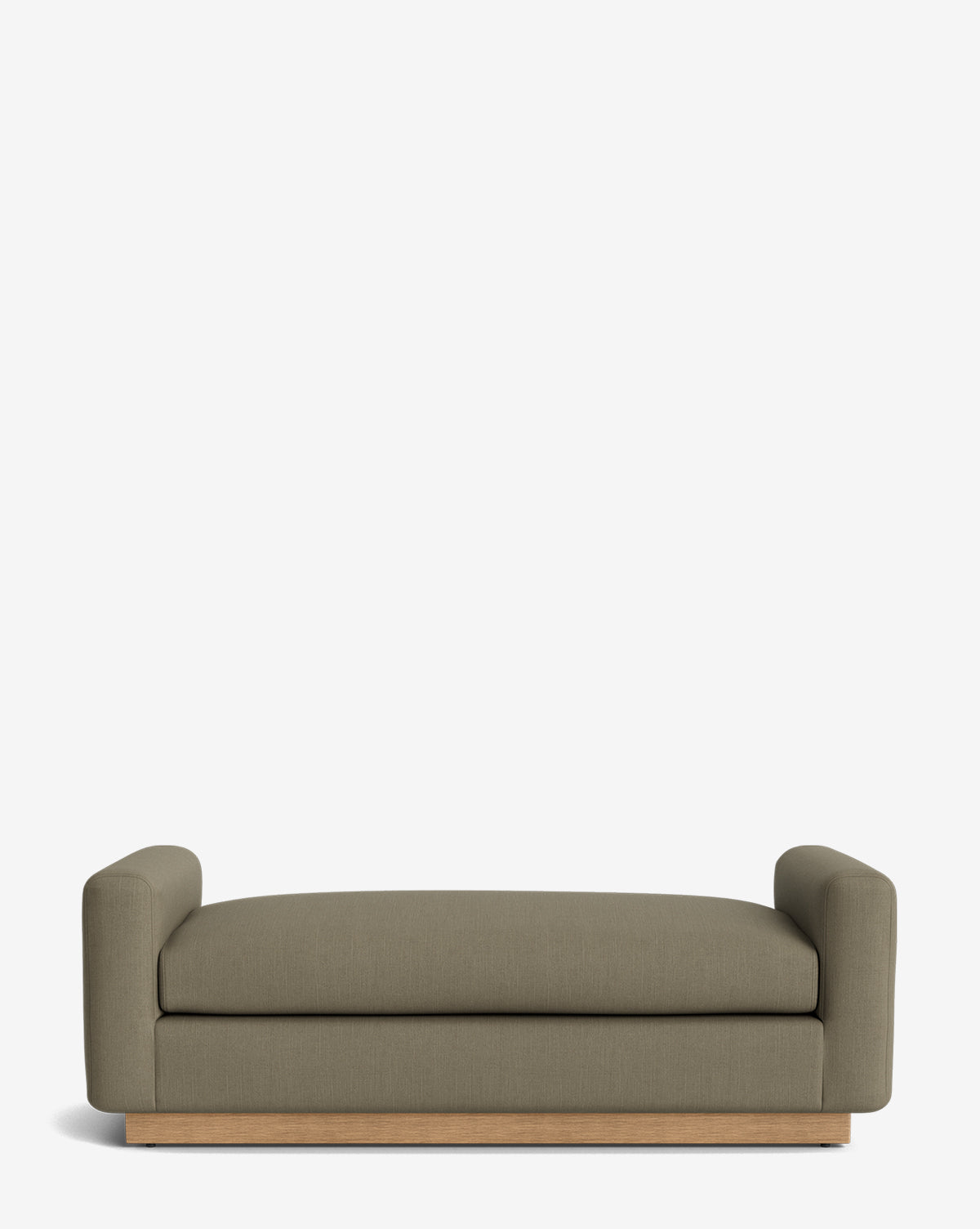 A modern olive-green sofa with low, rounded arms and a wooden base on a plain white background pairs beautifully with the Mansfield Bench, adding extra style and seating, by McGee & Co.