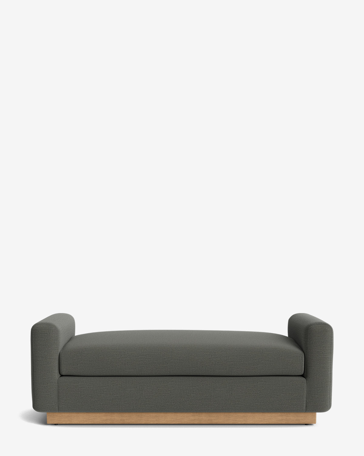 The Mansfield Bench features a modern dark gray upholstered design, low rounded armrests on each side, and a light wooden base, shown against a plain white background by McGee & Co.