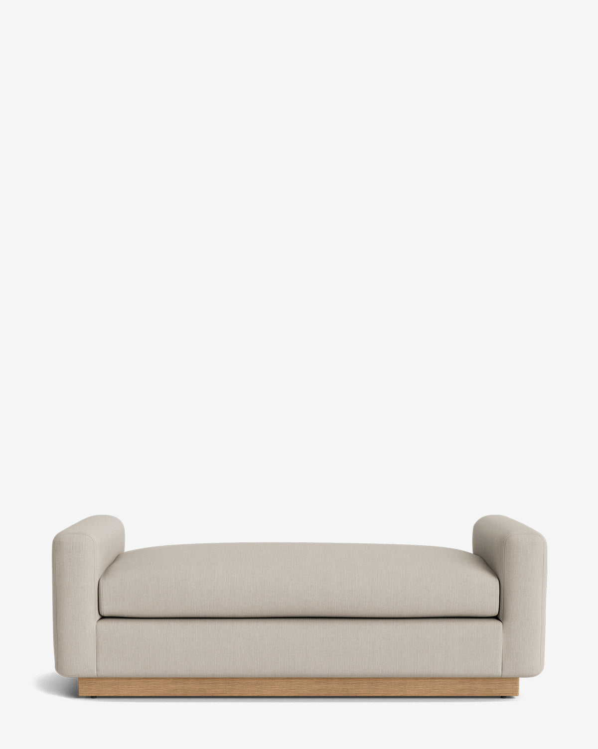 The Mansfield Bench is a modern bench with light beige upholstery, low rounded arms on both sides, and a wooden base, shown on a plain white background by McGee & Co.