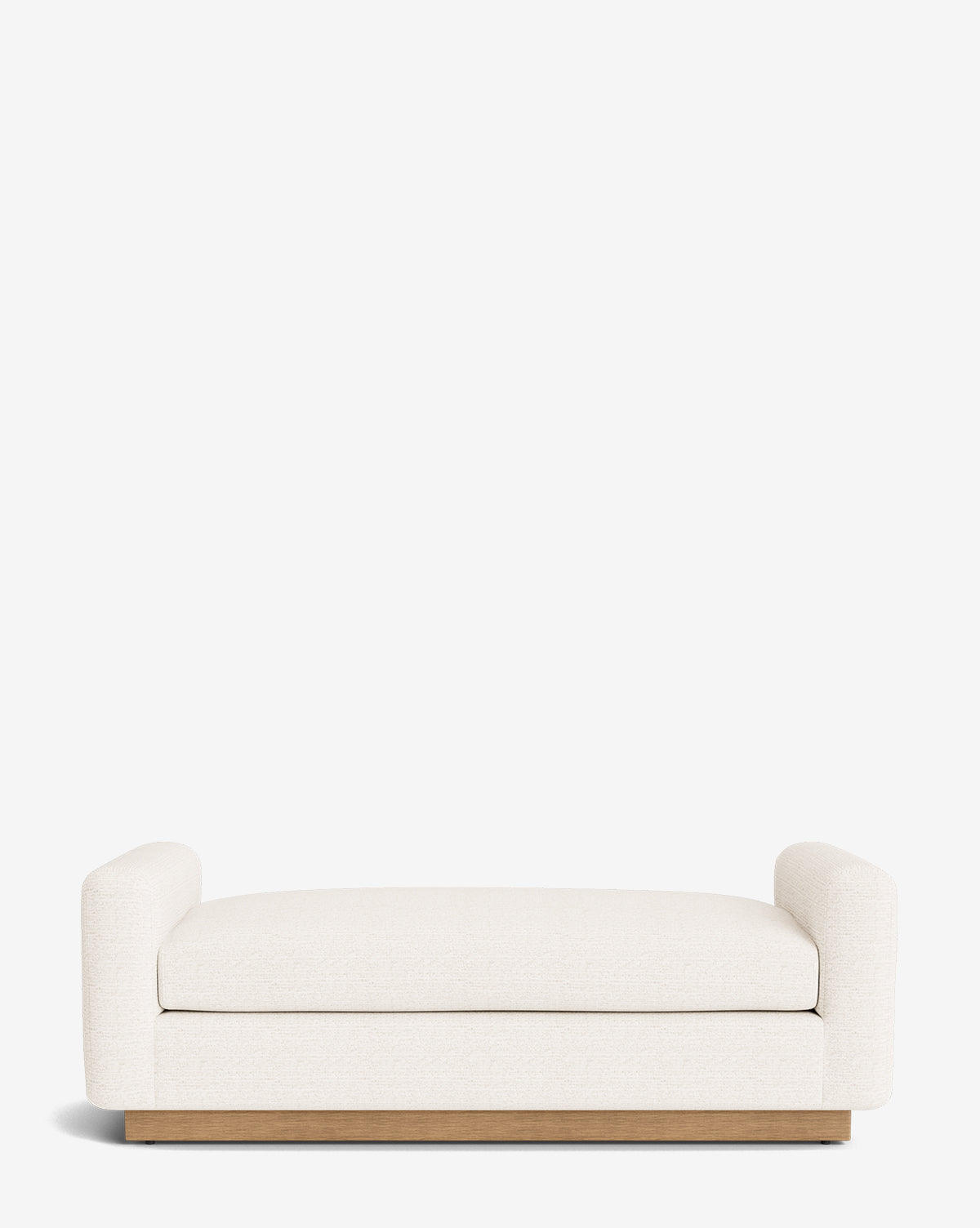 The Mansfield Bench is a modern, minimalist bench featuring a cream upholstered seat and arms on a low wooden base, shown against a plain white background by McGee & Co.