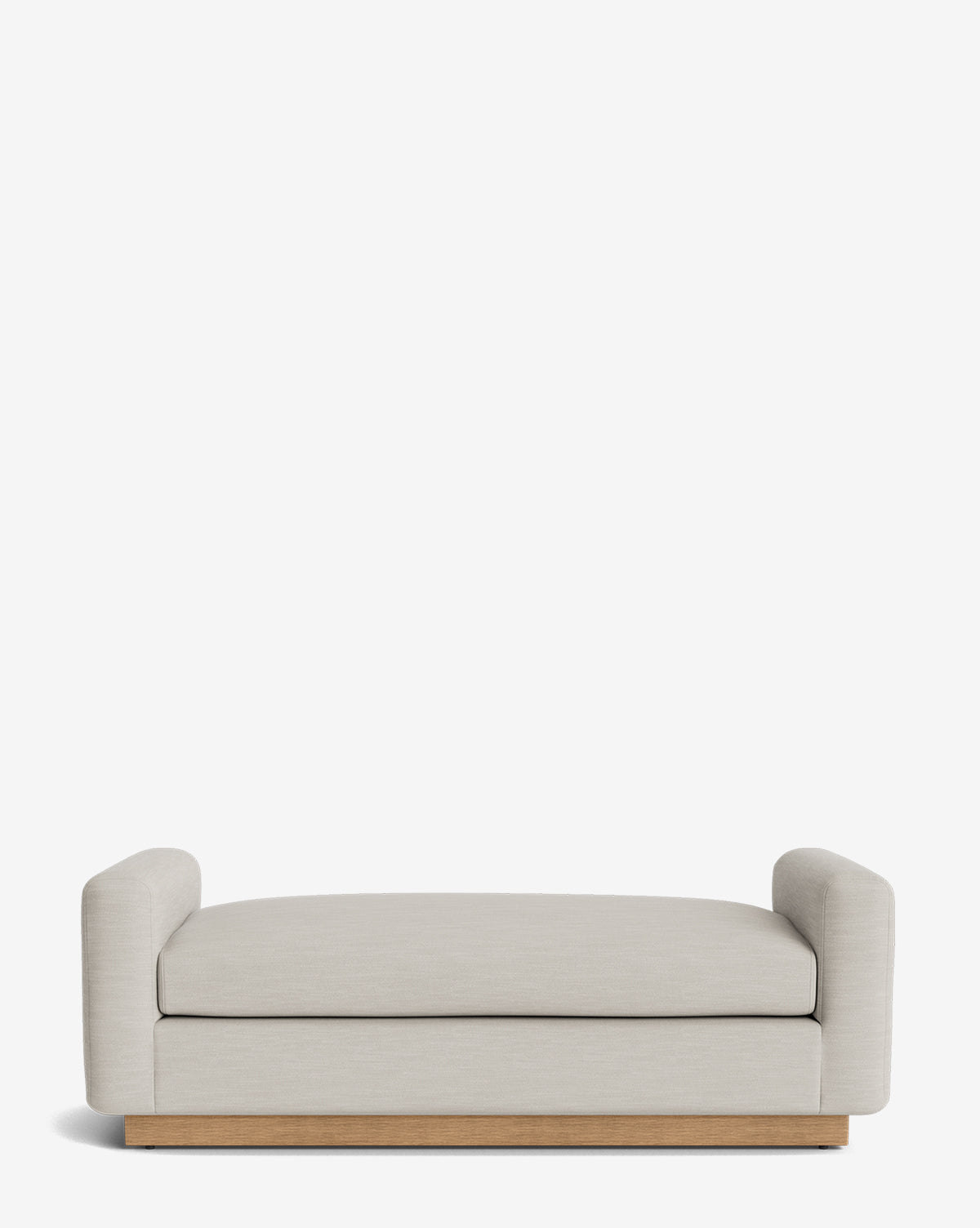 The Mansfield Bench is a modern, minimalist bench in light beige upholstery with low, rounded arms on each side and a wooden base, by McGee & Co.