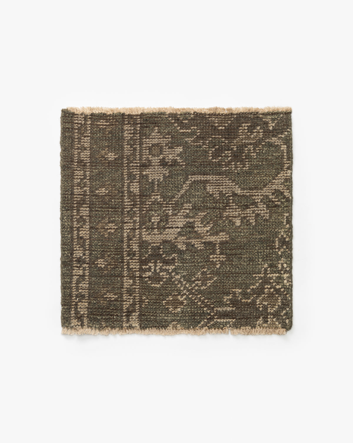 The Marola Hand-Knotted Rug Swatch features a rectangular design in dark olive green and beige wool, with a subtle intricate pattern and one fringed edge, shown against a white background by McGee & Co.