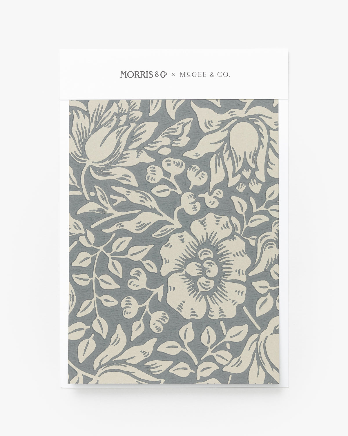 Certainly! Here’s your sentence with the exact string McGee & Co. blended to the end: The Morris & Co. x McGee & Co. Mallow Wallpaper Swatch by Sanderson Design Group, Inc. features a gray and cream floral pattern with large stylized flowers and leaves, inspired by classic wallpaper designs, McGee & Co.