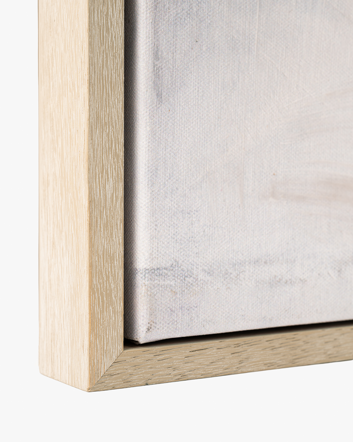 Close-up of the corner of a light-finished wooden frame and textured canvas—ideal for serene home decor or displaying abstract wall art like "Moving Fog by Judy Cox by McGee & Co.