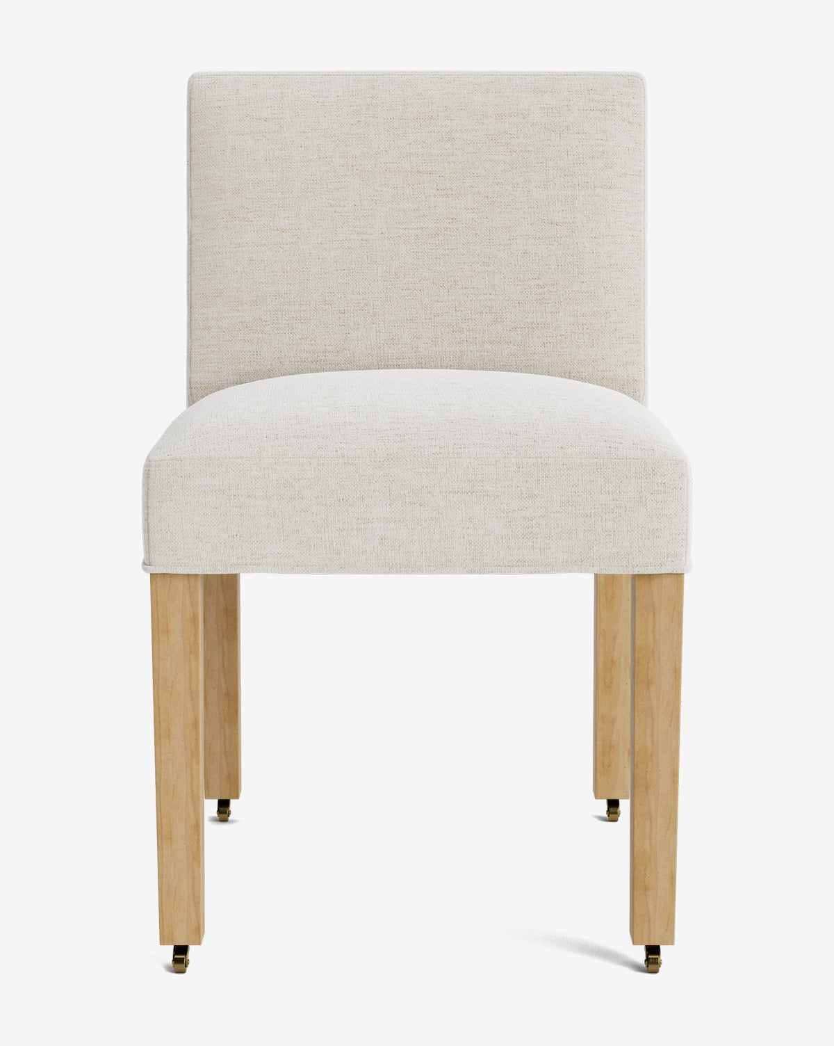 The Olivier Upholstered Dining Chair features a cream fabric seat and back, set on four light wood legs with brass casters, by McGee & Co. It is photographed against a plain white background.