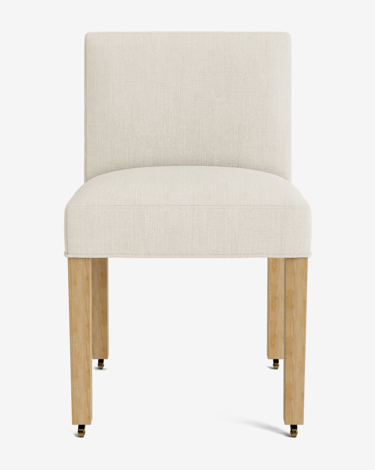 Front view of the Olivier Upholstered Dining Chair, featuring a modern armless design, cream high-quality fabric seat and backrest, and four light wood legs with brass casters on the front two legs, by McGee & Co.