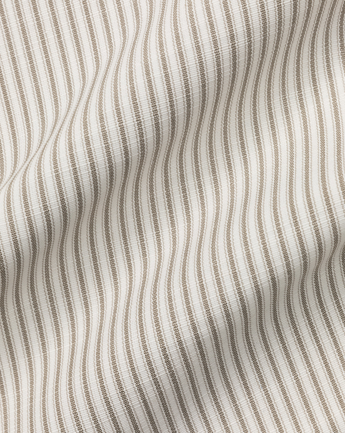 Close-up of the Perennials Upholstery Swatch in beige and white stripes, featuring gentle folds and a textured, flowing look. Evenly spaced vertical lines highlight the fabrics beauty and durable performance.