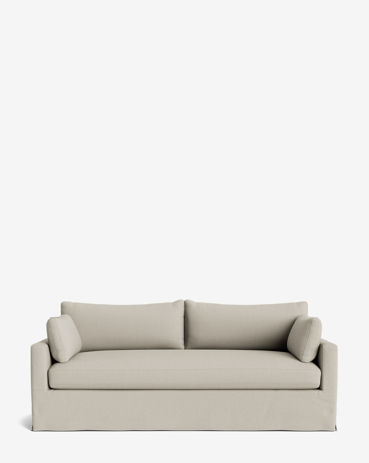 The Peterson Classic Slipcover Sofa (75-100) in light beige has two seat and back cushions, feather blend filling, and cylindrical bolster pillows, shown against a plain white background by McGee & Co.
