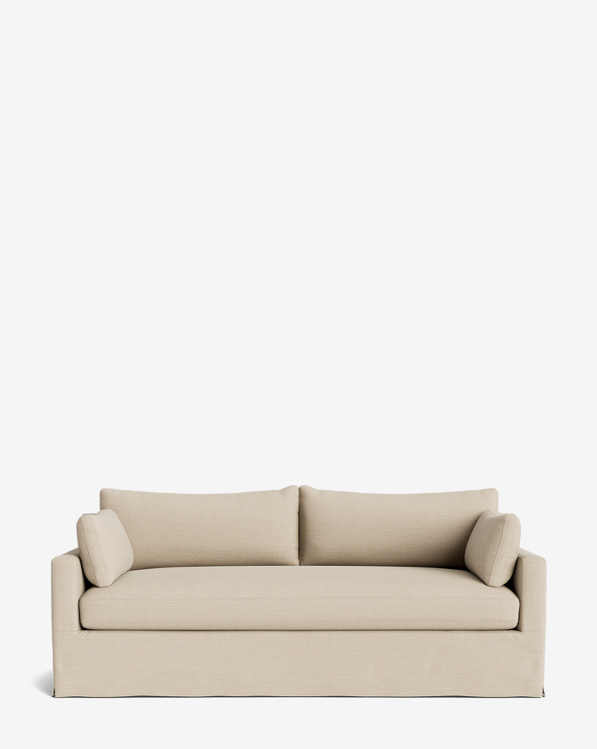 A beige Peterson Classic Slipcover Sofa (75-100) with modern lines, feather blend cushions, and two matching bolster pillows sits against a plain white background, by McGee & Co.
