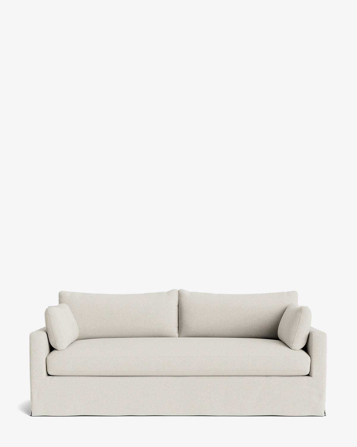 A Peterson Classic Slipcover Sofa (75-100) in light beige, featuring a straight backrest, two feather blend cushions, and matching bolster pillows, is set against a plain white background by McGee & Co.