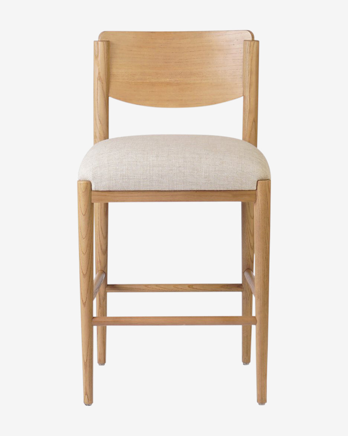 The Four Hands Reverie Stool features a natural wood frame, curved backrest, and cushioned beige fabric seat. Photographed from the front against a white background, it’s ideal for bringing warmth to your kitchen. McGee & Co.