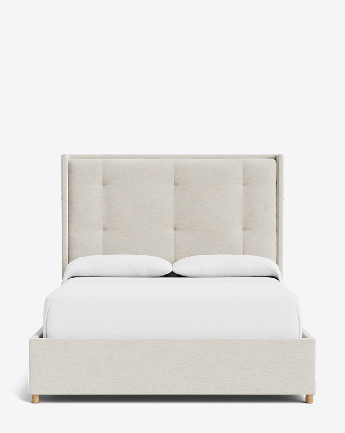 The Ria Bed is a modern, customizable upholstered bed in beige with a tall tufted headboard, crisp white bedding, and two pillows, displayed against a plain white background by McGee & Co.