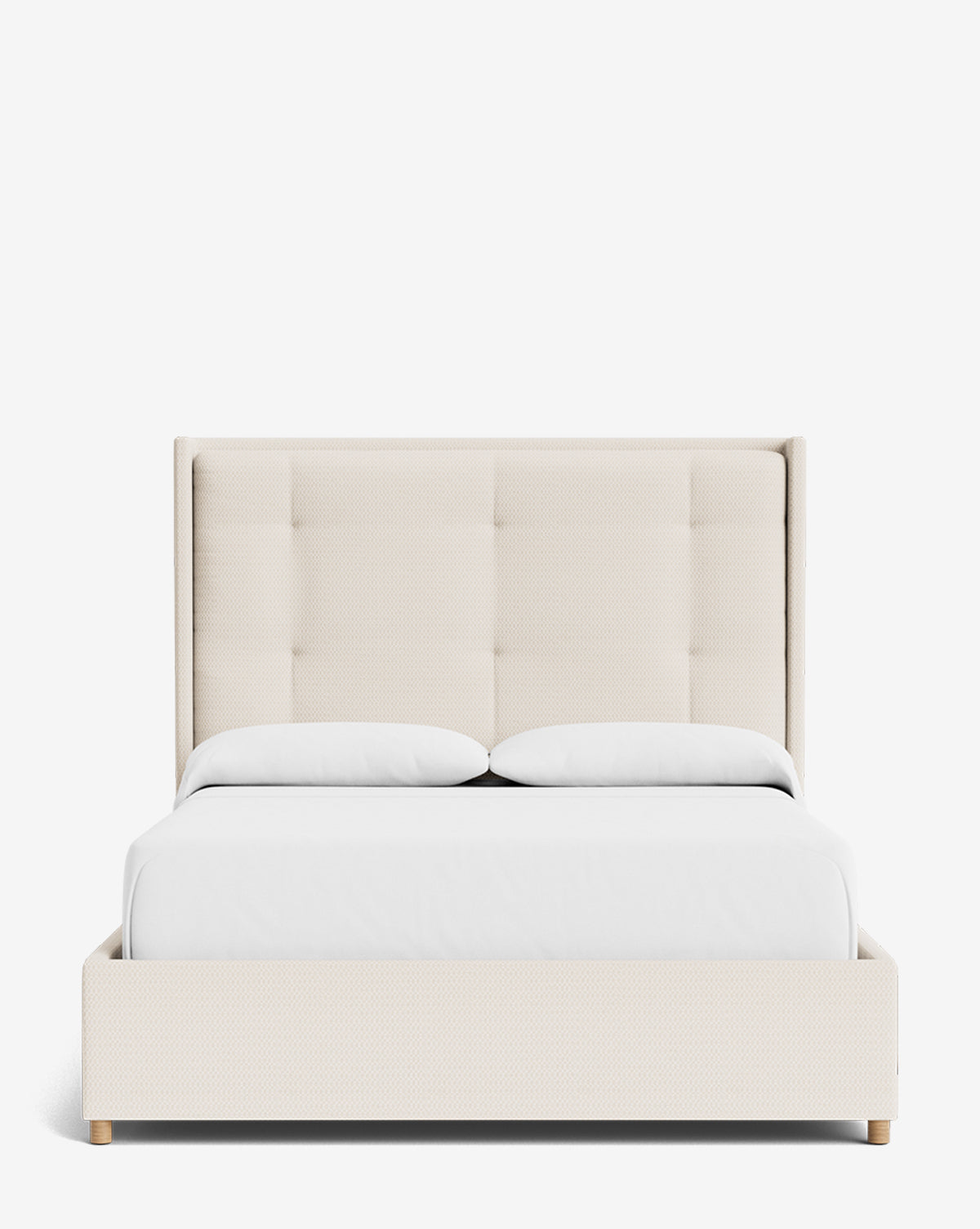 The Ria Bed, a modern cream-colored upholstered bed with a tall tufted headboard, white bedding, and light wooden legs, is shown against a plain white background. This customizable piece adds elegance to any bedroom, by McGee & Co.