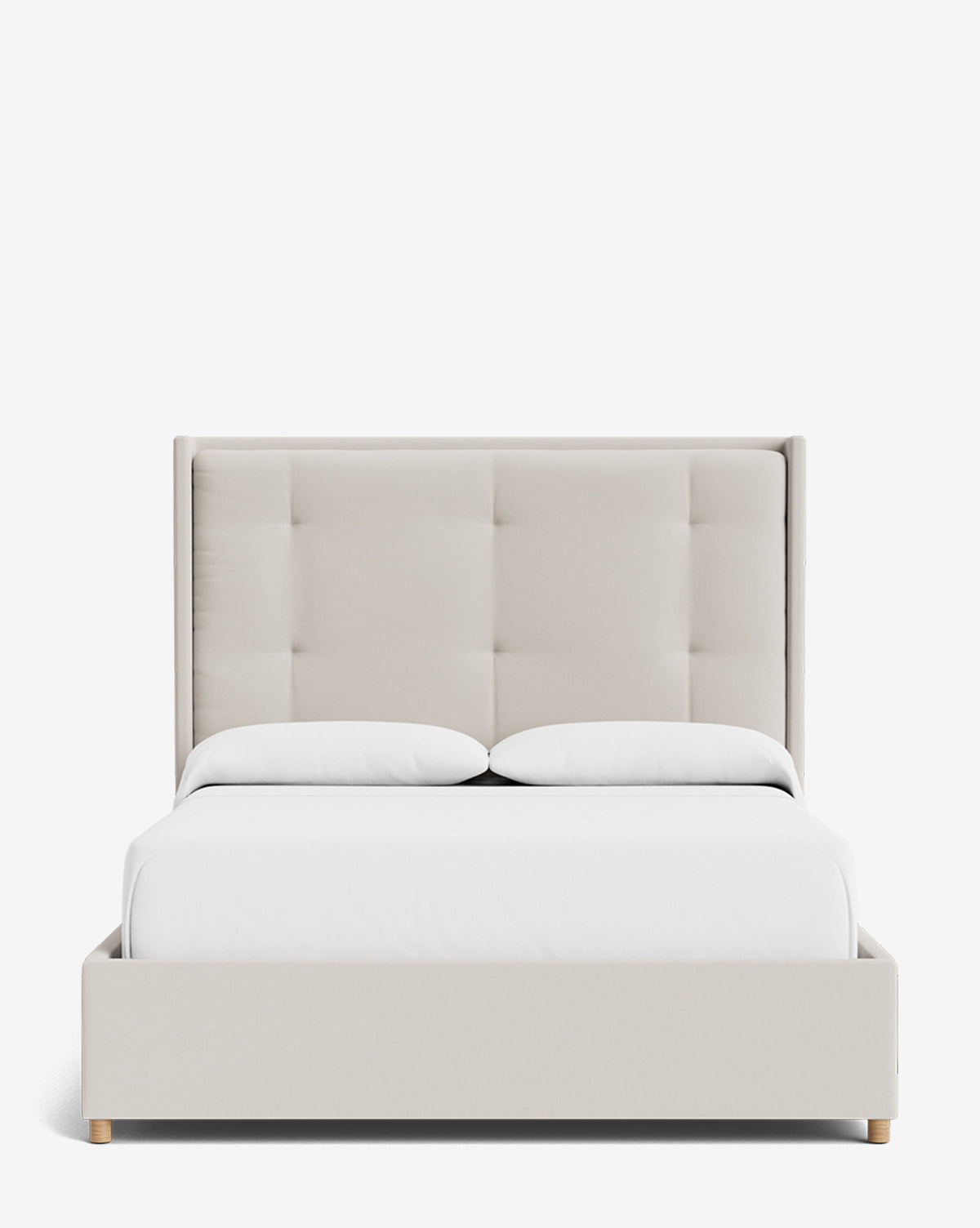 The Ria Bed is a modern, customizable upholstered bed featuring a tall, tufted beige headboard, white bedding, and two pillows, shown from the front against a plain white background by McGee & Co.