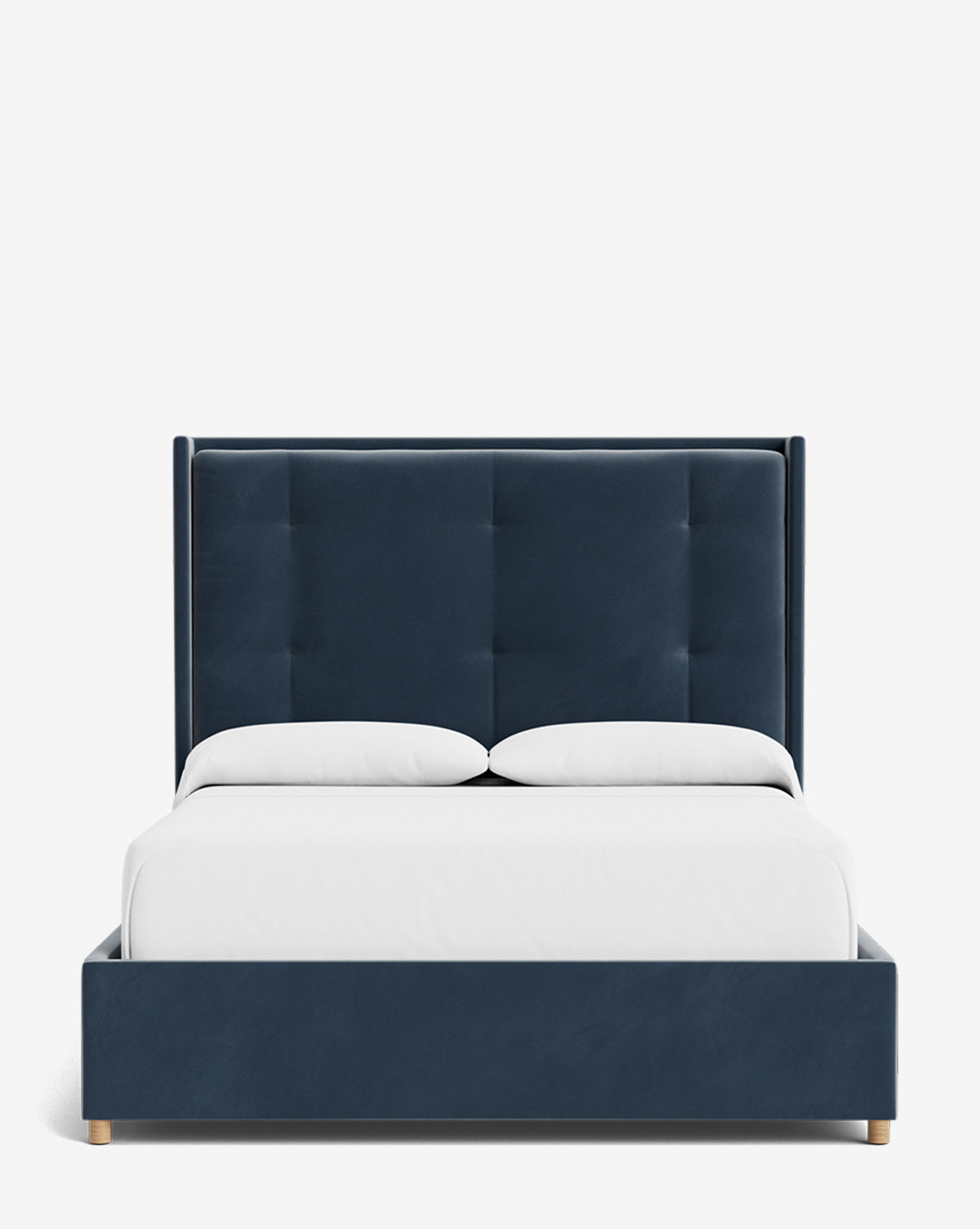The Ria Bed is a modern navy blue upholstered bed with a tall, tufted headboard and customizable options, shown with crisp white bedding and two white pillows, all viewed from the front against a plain white background, by McGee & Co.