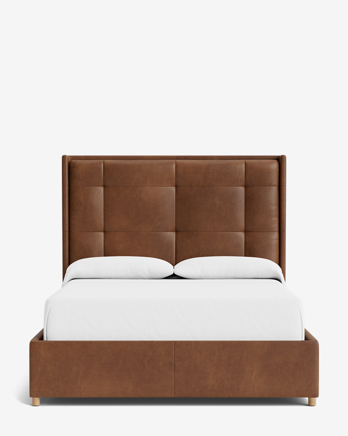 The Ria Bed is a modern upholstered bed with a tall, brown tufted headboard and matching frame. Customizable, it features white sheets and pillows, all set against a crisp white background, by McGee & Co.