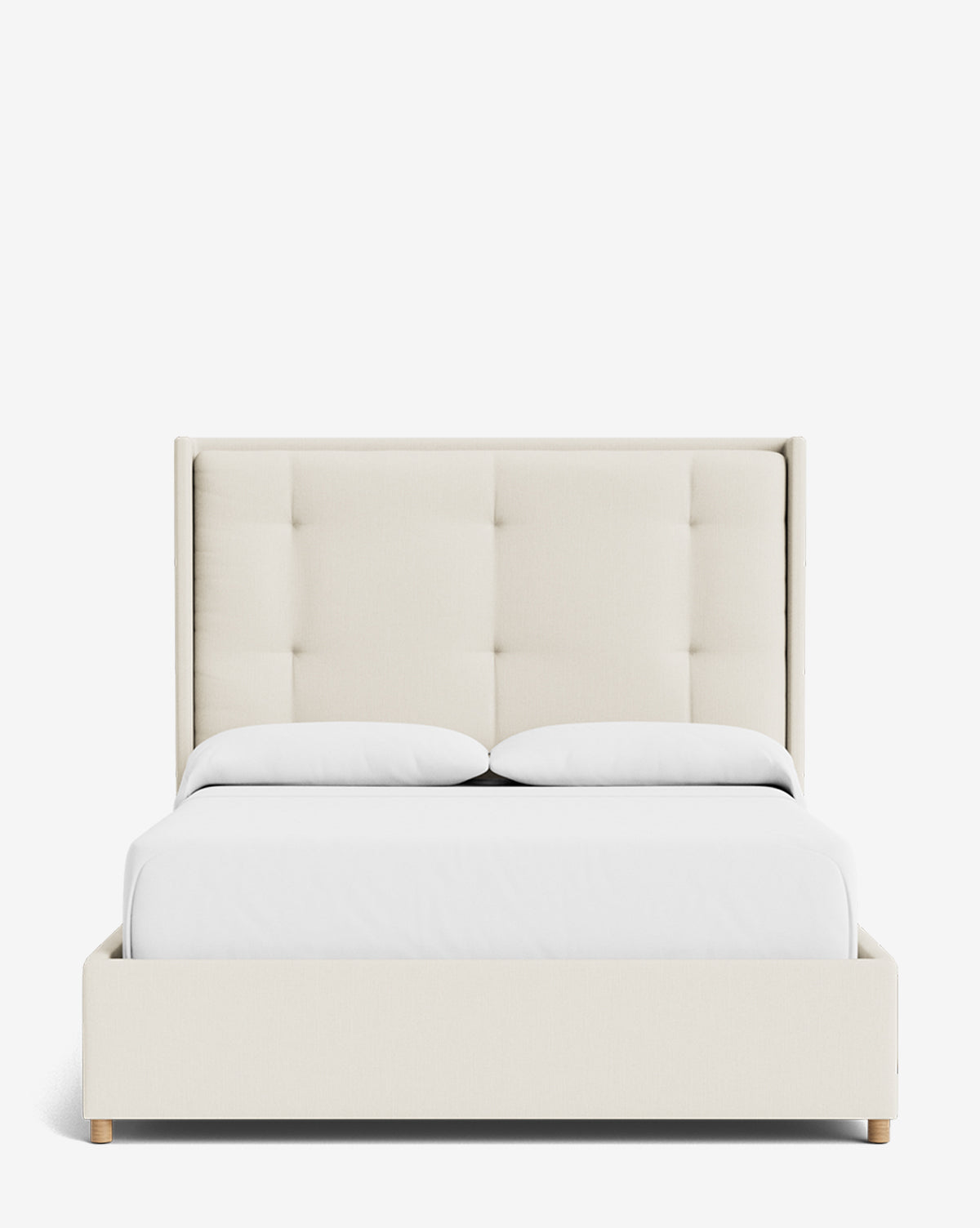 The Ria Bed features a modern, customizable design with a tall tufted cream headboard, white bedding, two white pillows, and light wooden legs, displayed against a plain white background by McGee & Co.