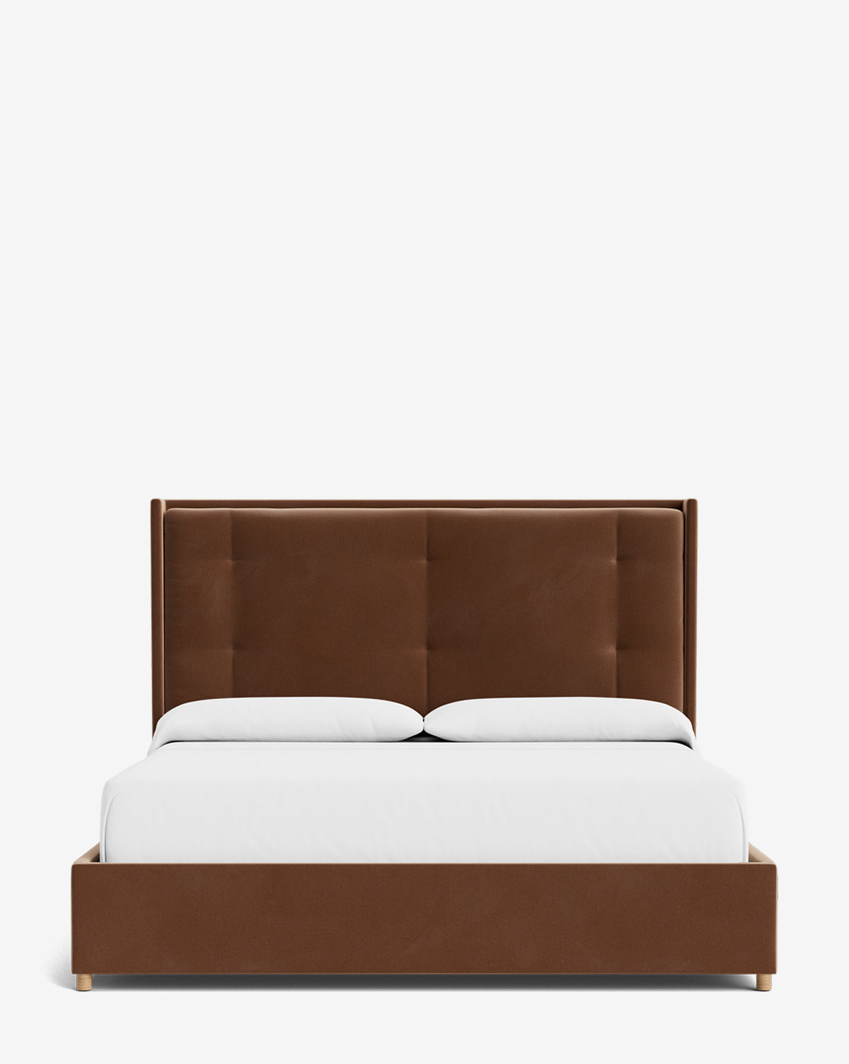 The Ria Bed is a modern upholstered bed with a customizable brown frame and headboard, featuring a minimalist design. It is neatly made with white bedding and two pillows, set against a plain white background by McGee & Co.