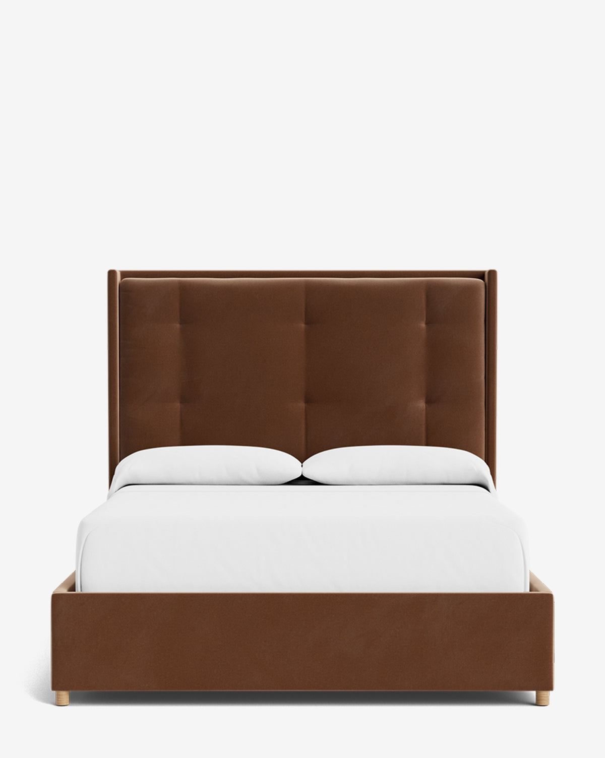 The Ria Bed is a modern, customizable brown upholstered bed featuring a tall tufted headboard, white bedding, and two white pillows, displayed against a plain white background by McGee & Co.