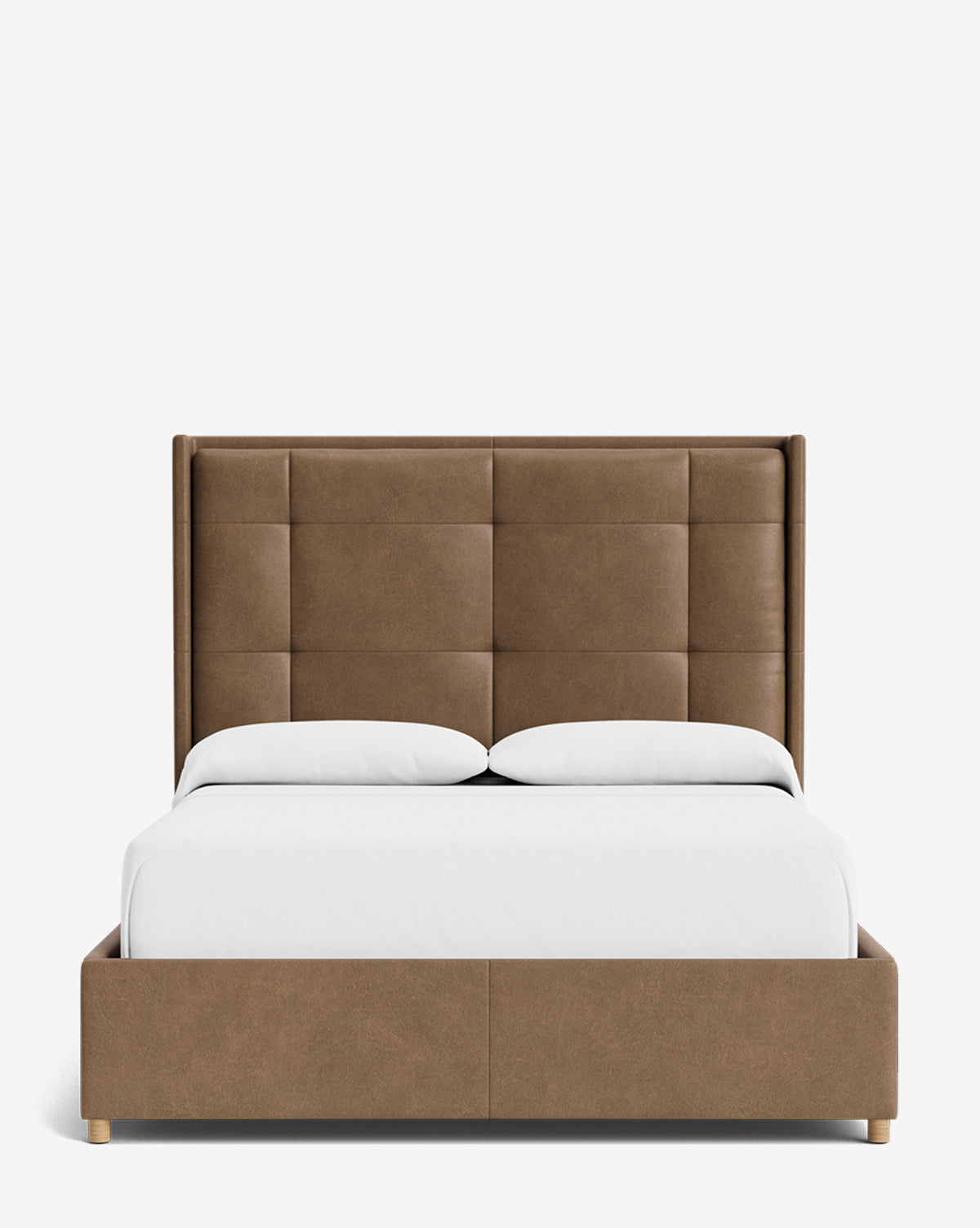 The Ria Bed features a modern, customizable brown upholstered frame with a tall, square-patterned tufted headboard, white bedding, and two pillows, displayed against a plain white background by McGee & Co.