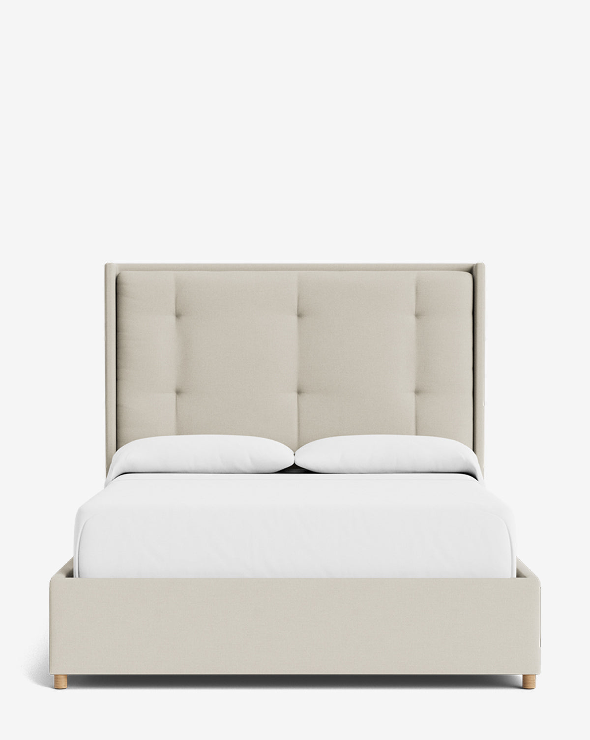 The Ria Bed features a tall, light beige upholstered tufted headboard, two white pillows, a white duvet, and simple light wood feet. Its customizable frame has clean lines and is set against a plain white background, by McGee & Co.